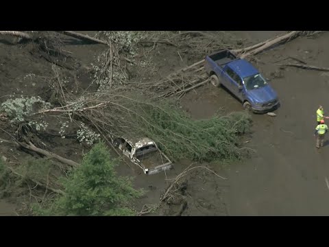 Mudslide traps vehicles on Barre, Vermont, road amid flash flooding