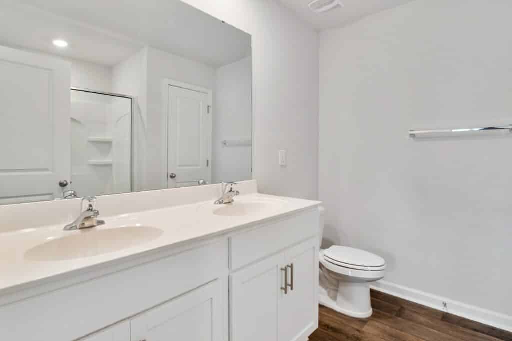 White bathroom with vanity and toilet