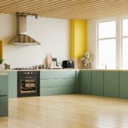 sage green kitchen cabinets with black countertops