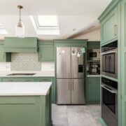 sage green kitchen cabinets with white countertops