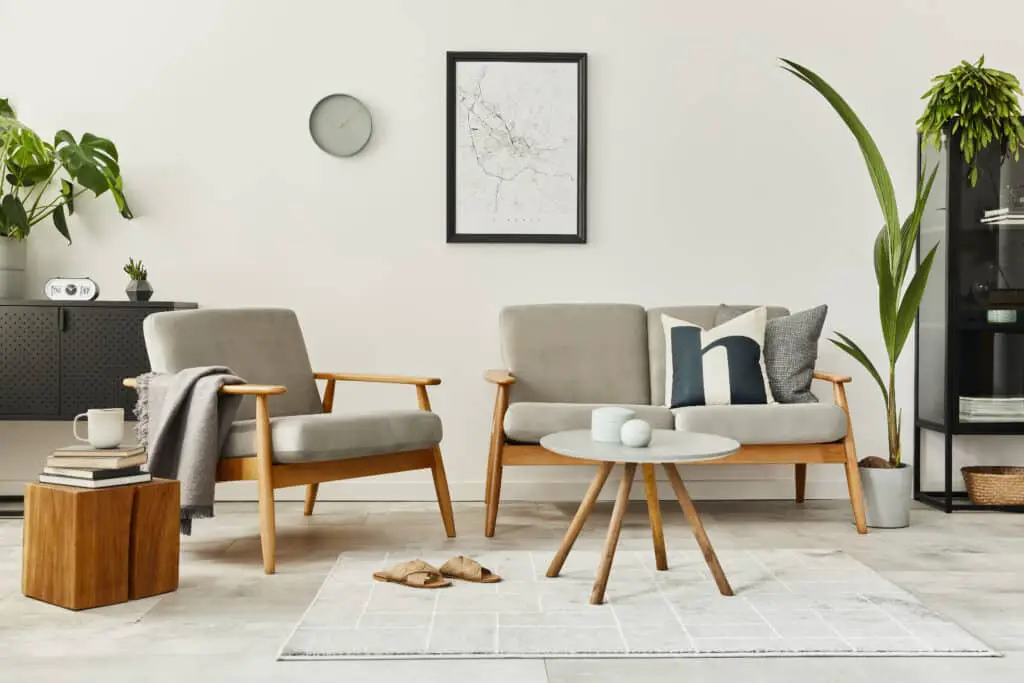 Modern retro concept of home interior with design sofa, armchair, coffee table, plants, mock up poster map, carpet and personal accessories Stylish home decor of living room.