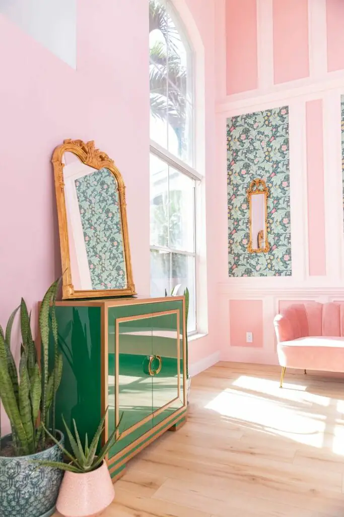 pink wall with green cabinet