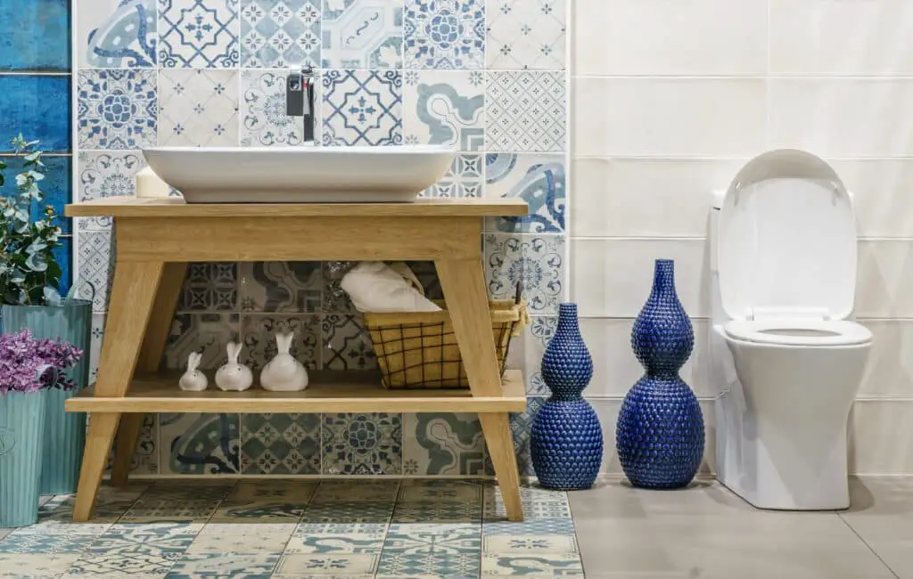 Modern spacious bathroom with bright tiles with toilet and sink. Side view moroccan inspired bathroom
